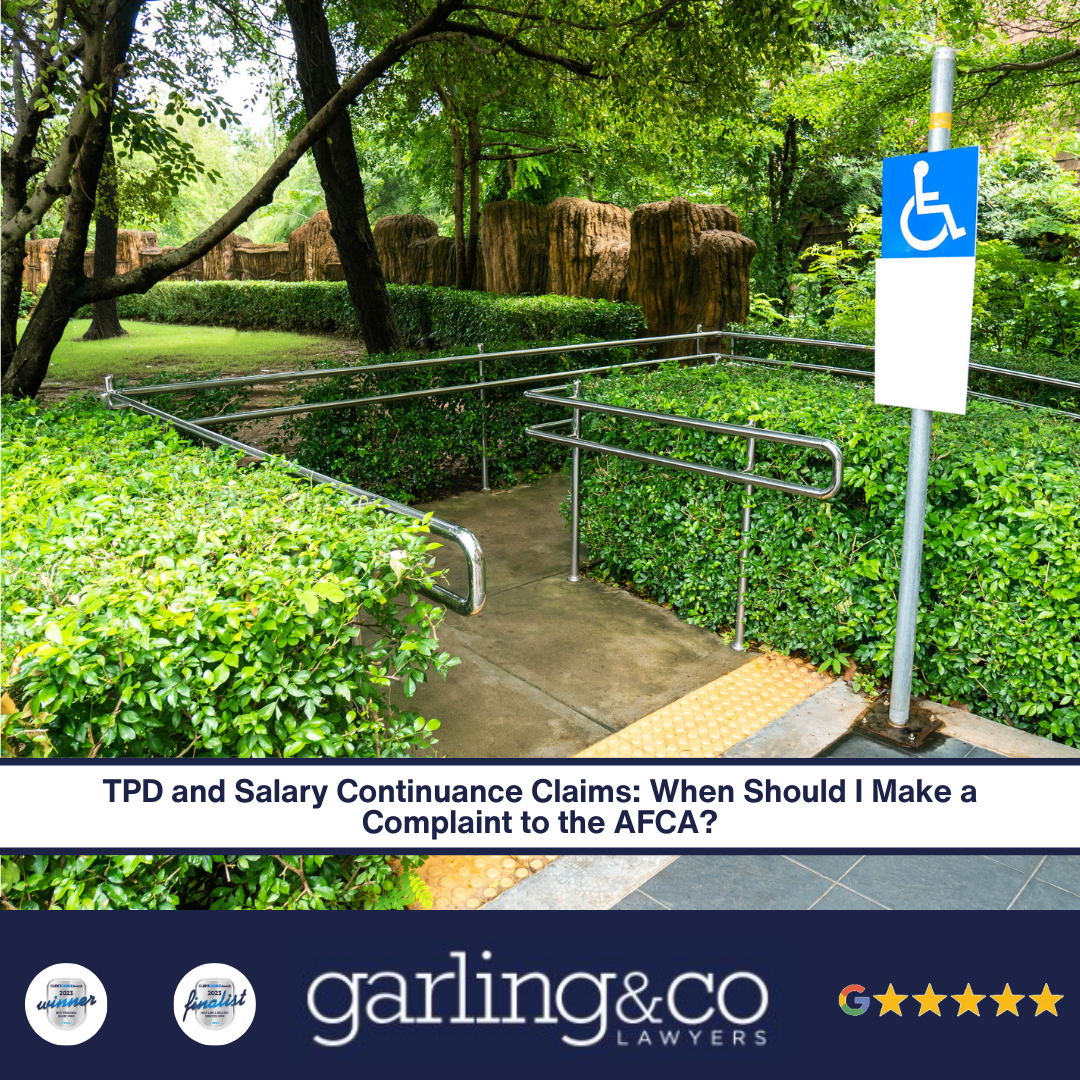 A blue disability sign next to a ramp and railing surrounded by greenery with the caption “TPD and Salary Continuance Claims_ When Should I Make a Complaint to the AFCA”