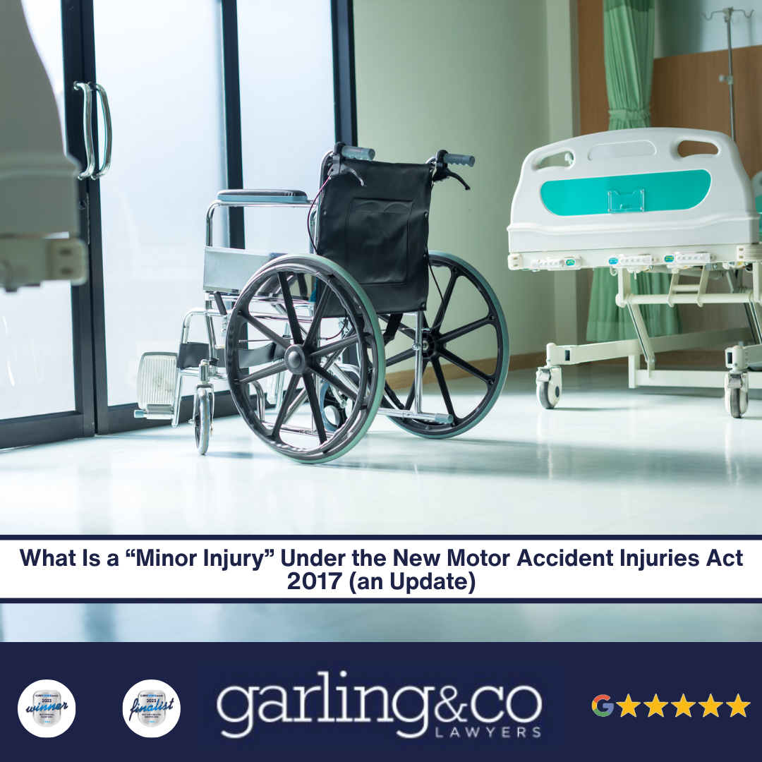 A hospital room with a wheelchair facing the door next to a hospital bed with the caption “What Is a Minor Injury Under the New Motor Accident Injuries Act 2017 an Update”.