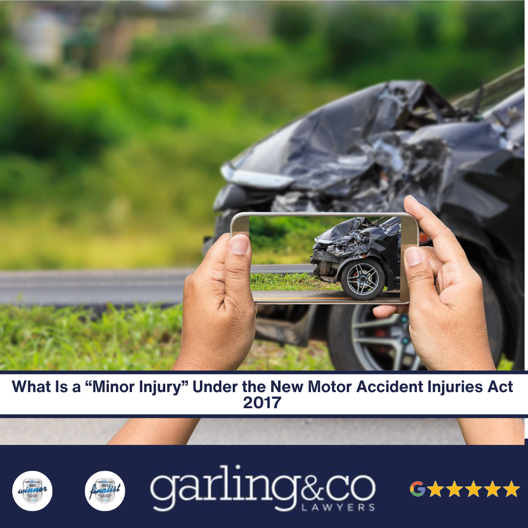 A image of a person taking a photo of the front of a wrecked car.