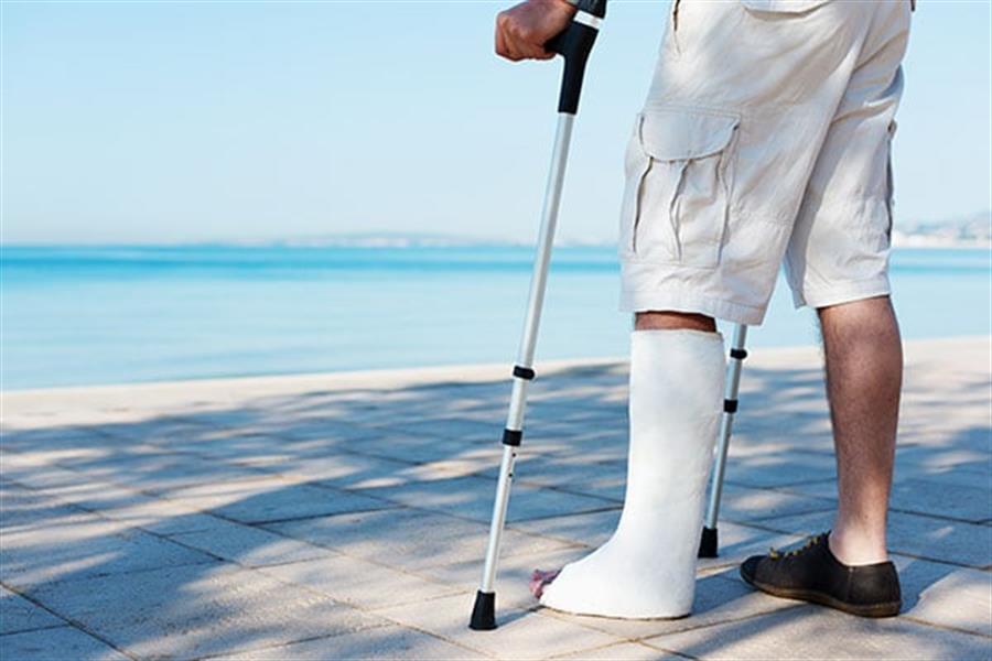 Person with injured leg using crutches