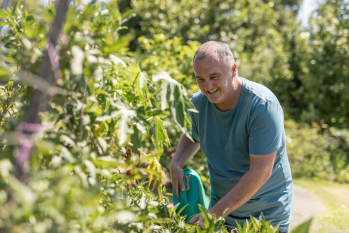 workers compensation claims NSW. Man watering garden